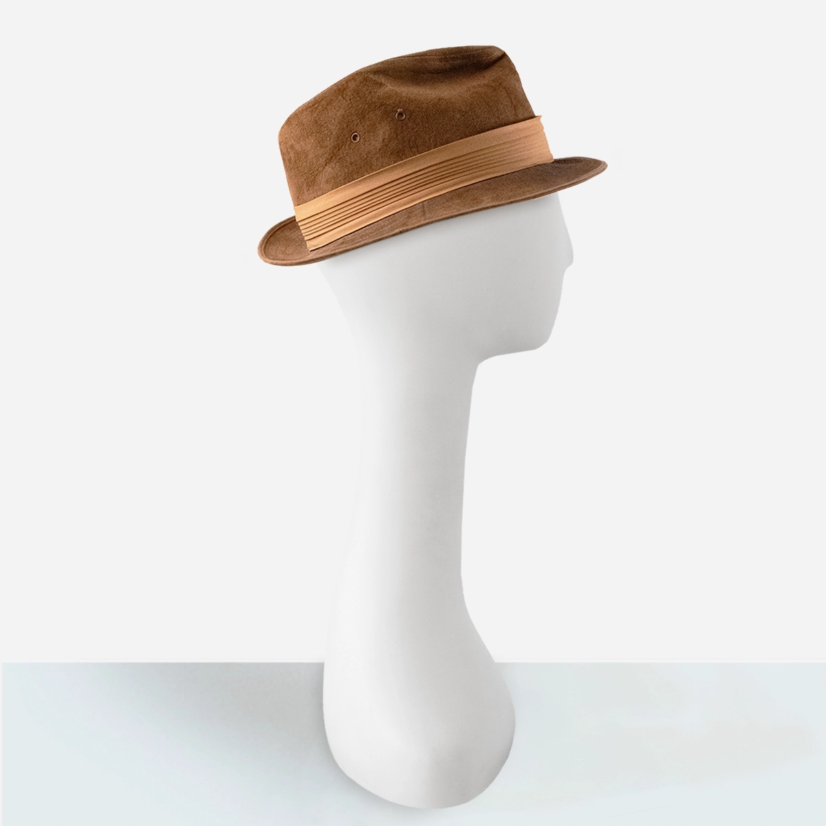 Side view of vintage brown suede trilby with upturned back brim.