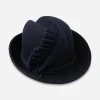 vintage blue ruffle hat Early 1960s navy blue sculptural felt hat with velvet ruffle trim, side view.