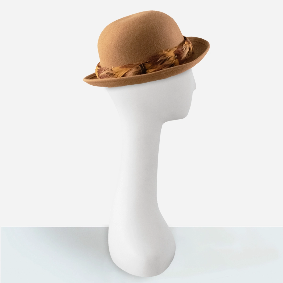 womens tan bowler hat 1970s Fabini camel wool bowler hat with pheasant feather band.