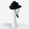 Side view of 1960s navy Breton hat showing tiered dome crown.