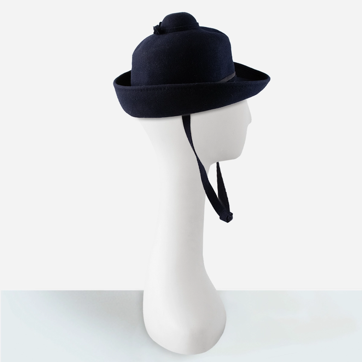 Side view of 1960s navy Breton hat showing tiered dome crown.