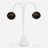 VIntage black enamel bird earrings Laurel Burch bird motif enamel earrings on display stand.