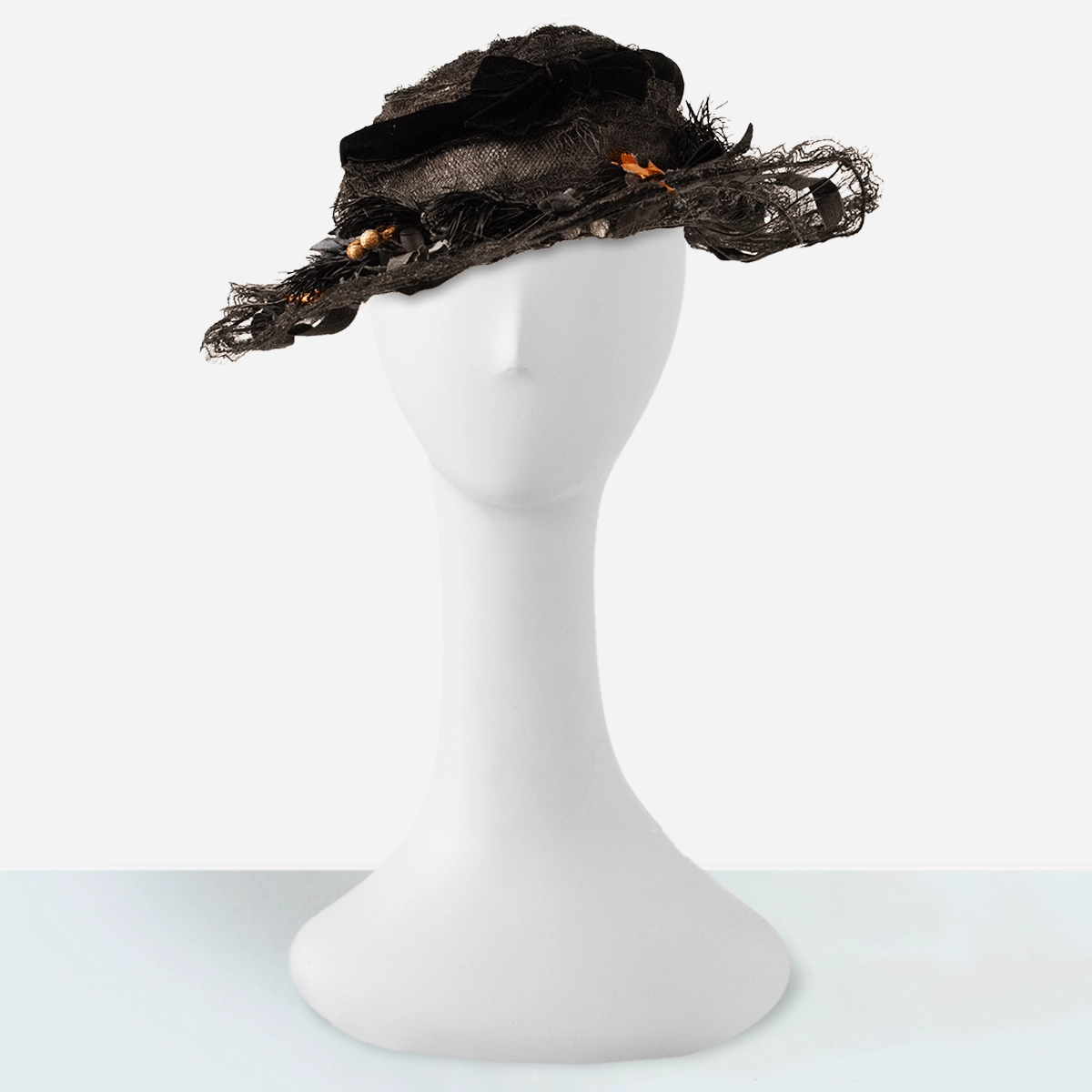Edwardian black horsehair picture hat with wire brim and silk flowers front view.