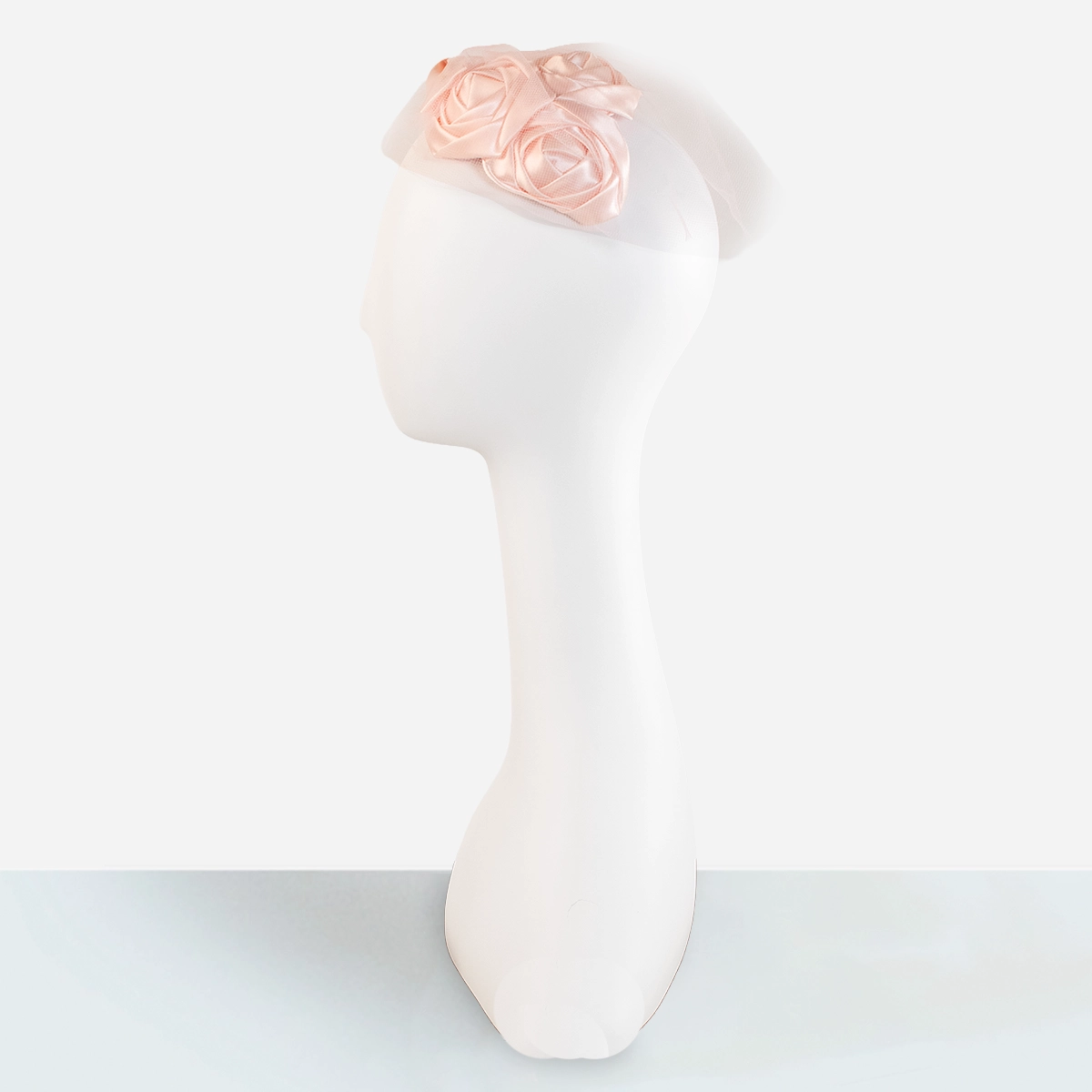 Vintage pink flower half hat side view on mannequin