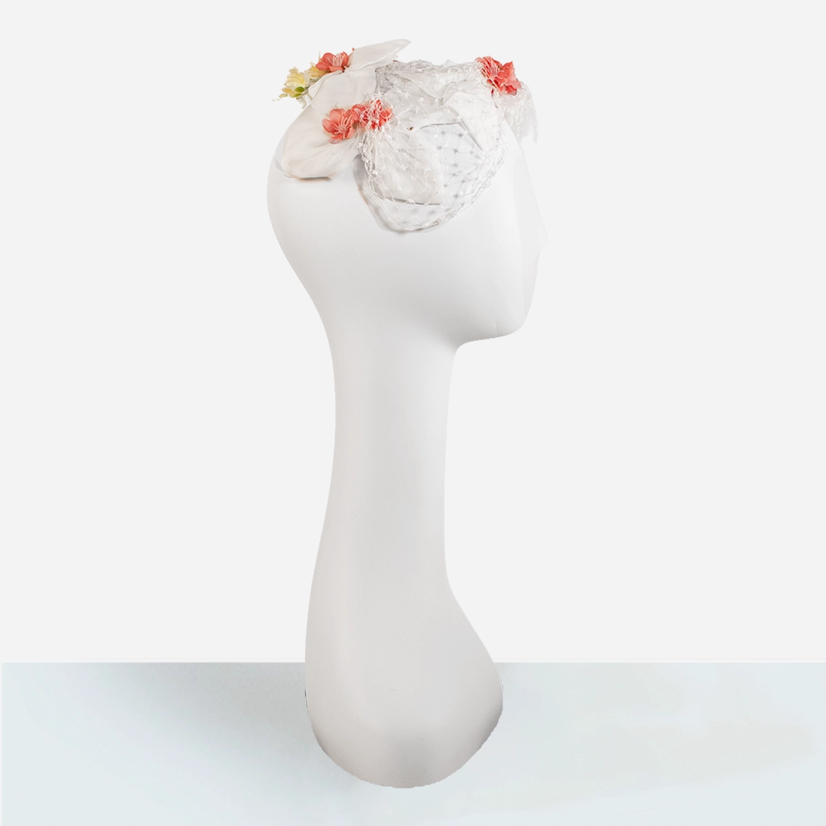Side view 1950s floral half hat with netting and fabric petals