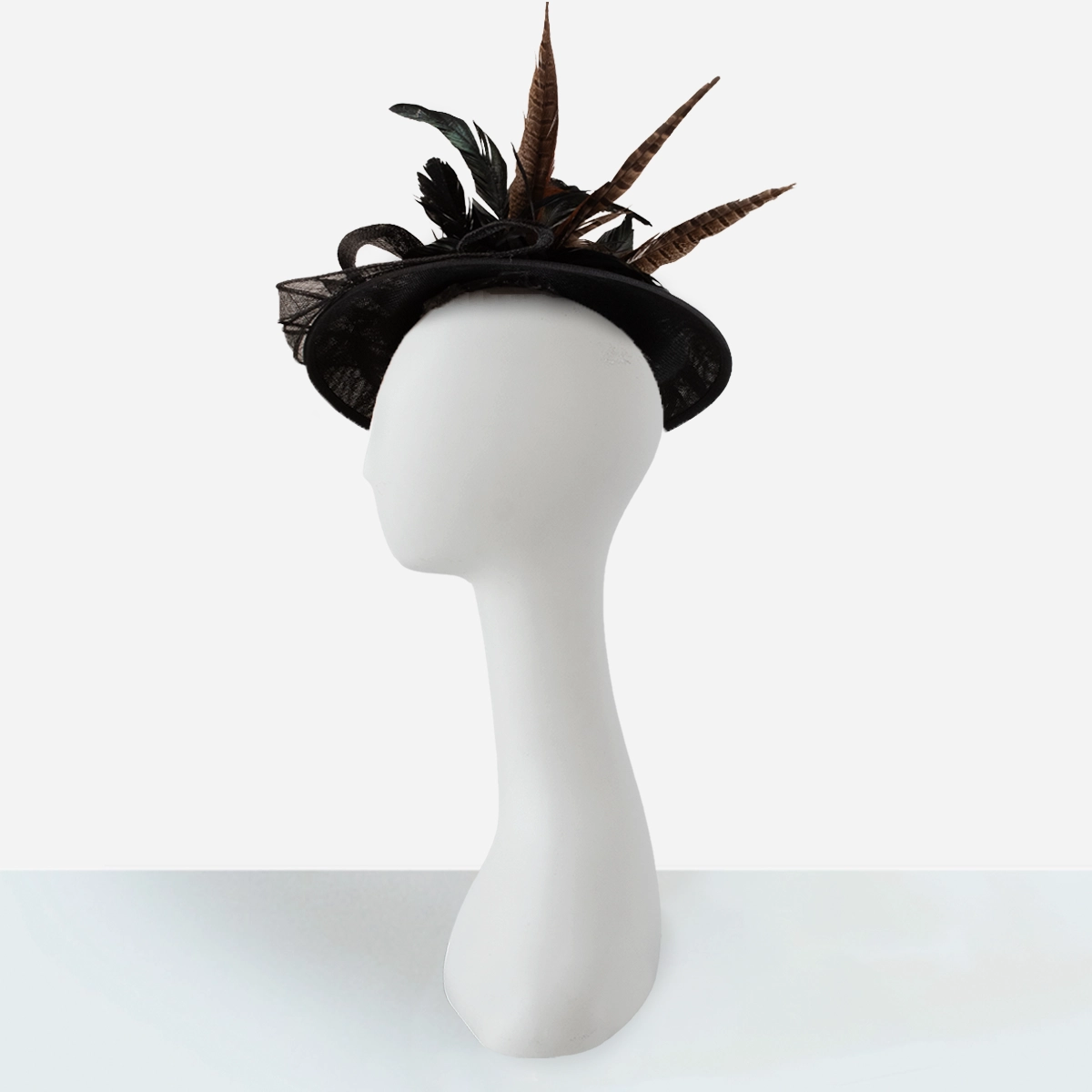 black feathered tilt hat on mannequin side view