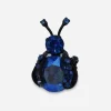 Vintage Warner blue rhinestone bug brooch with faceted body stone and japanned metal