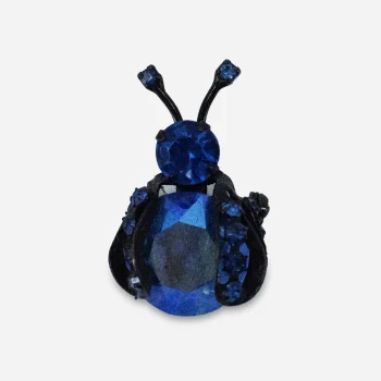 Vintage Warner blue rhinestone bug brooch with faceted body stone and japanned metal