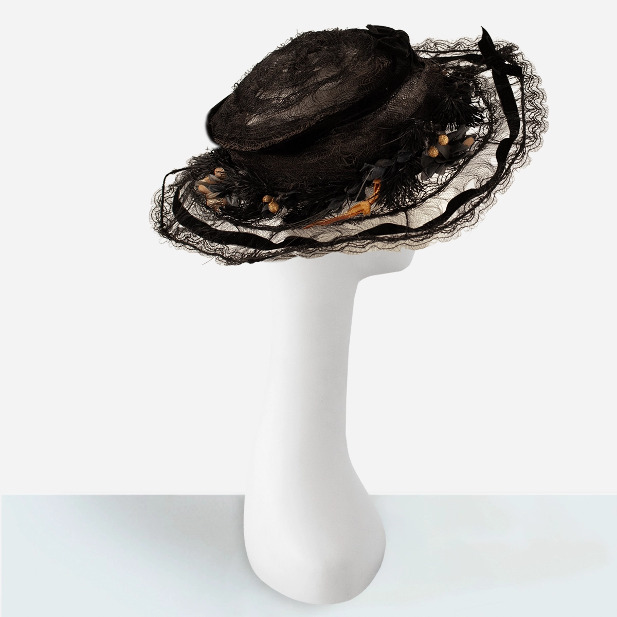 Wide brim horsehair braid and silk flowers on antique black hat.