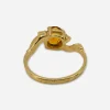 4K stamp inside band of vintage gold ring with topaz-colored glass stone.