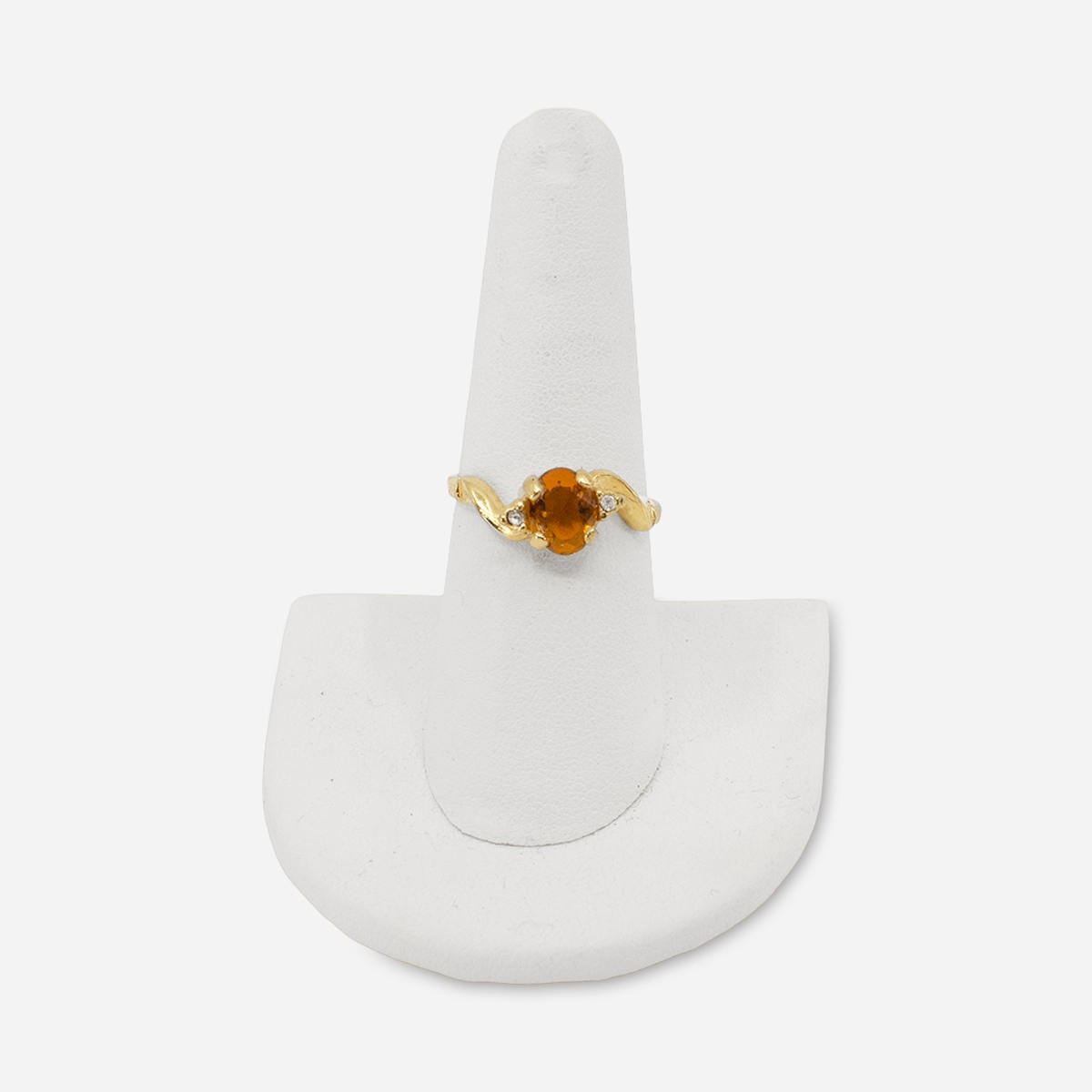 Vintage 14K gold ring displayed on stand, topaz-colored glass center stone.