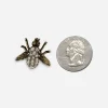 Small vintage fly scatter pin size comparison with quarter