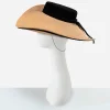vintage straw cartwheel hat Side view of vintage straw cartwheel hat with black velvet trim and wide brim
