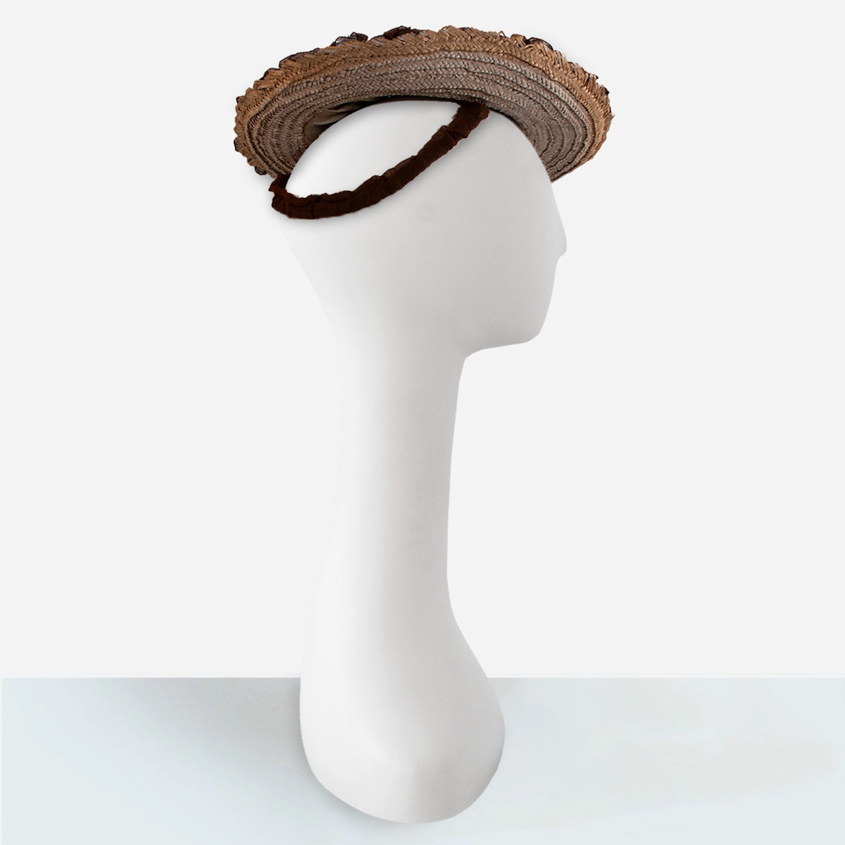 1930s brown ruffled straw hat Side view of 1930s tan straw tilt hat with brown ruched brim edging and attached strap.