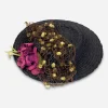 1930s floral tilt hat 1930s black straw tilt hat by Carson Pirie Scott with layered brim design, fuzzy ball veiling, and red silk flowers.