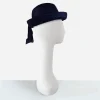 Side view of 1960s navy blue straw roller hat with upturned brim