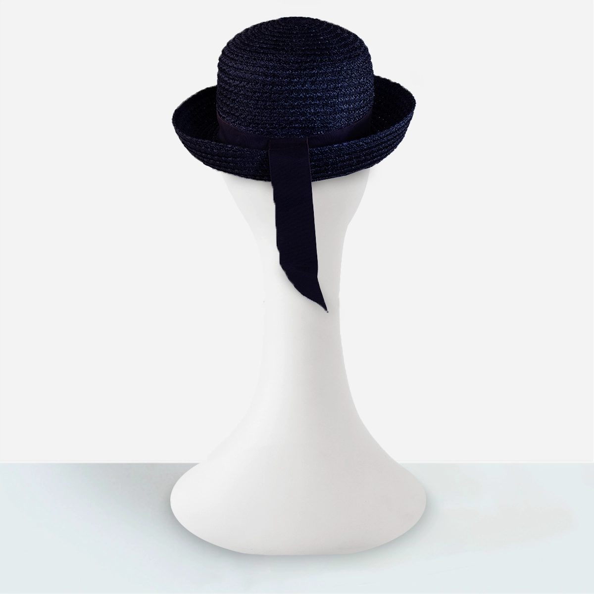 1960s navy blue roller hat 1960s navy blue straw roller hat with trailing grosgrain ribbon detail rear view