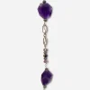 Closeup of long purple faceted glass necklace with decorative silver links and glass bead accents.