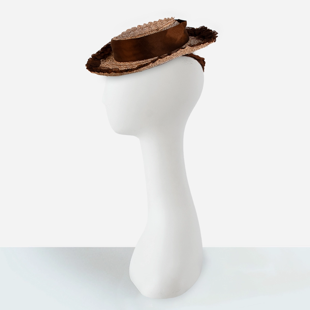 Womens 1930s straw tilt hat 1930s tan straw tilt hat with brown silk band and ruched brim trim.
