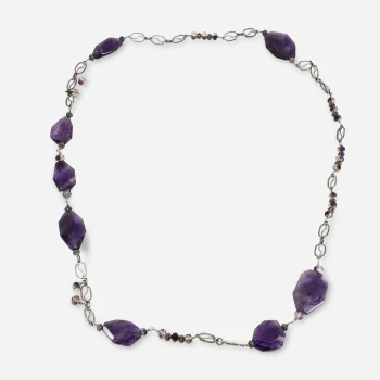 Vintage long purple glass necklace featuring irregular faceted beads and silver-tone openwork links.