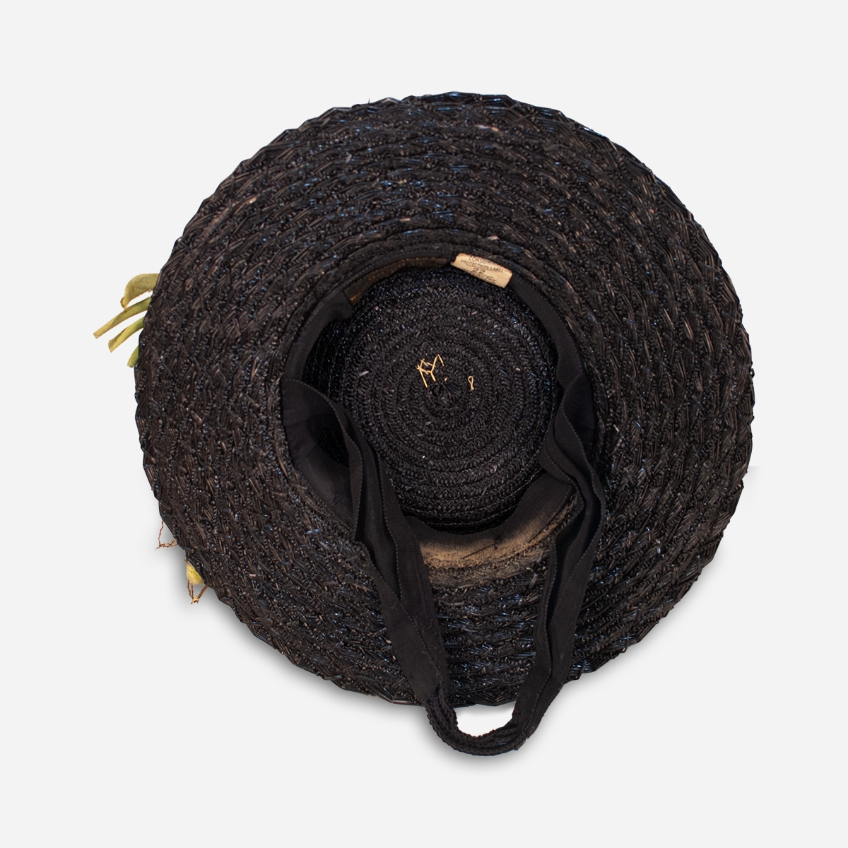 Inside view of 1930s black straw tilt hat showing layered brim construction and support strap.