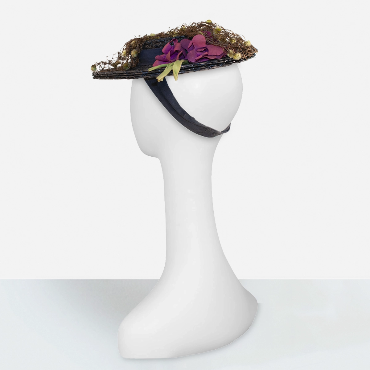 Vintage black 1930s tilt hat with sculptural layered brim design, novelty veiling, and red flowers, rear view