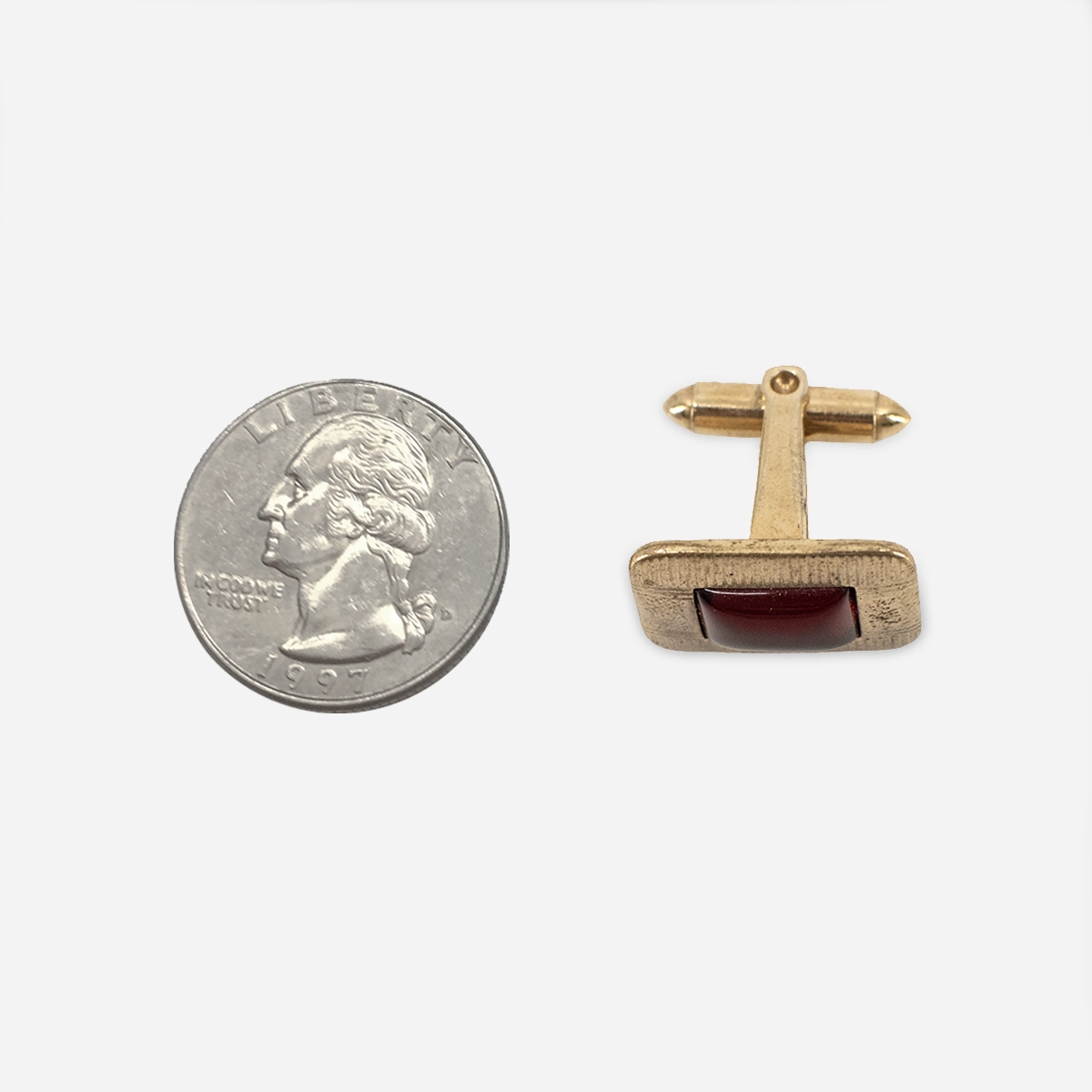 1950s men’s gold-tone cufflinks with red Lucite-style center shown beside quarter for scale.