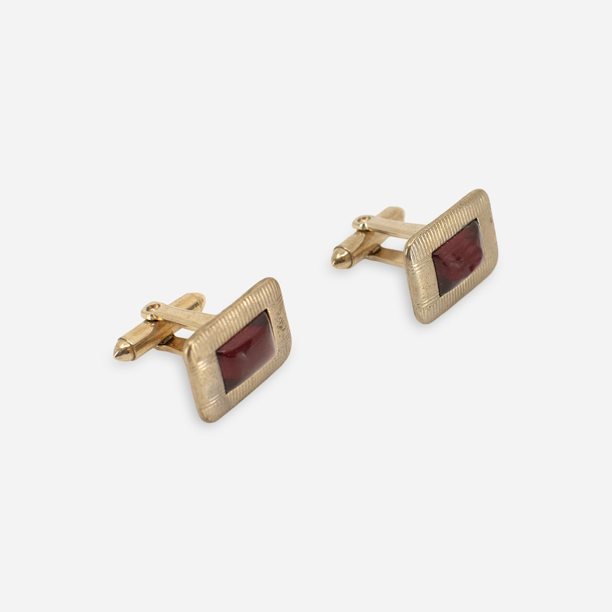 Pair of vintage gold-tone rectangular cufflinks with red molded acrylic cabochon centers.