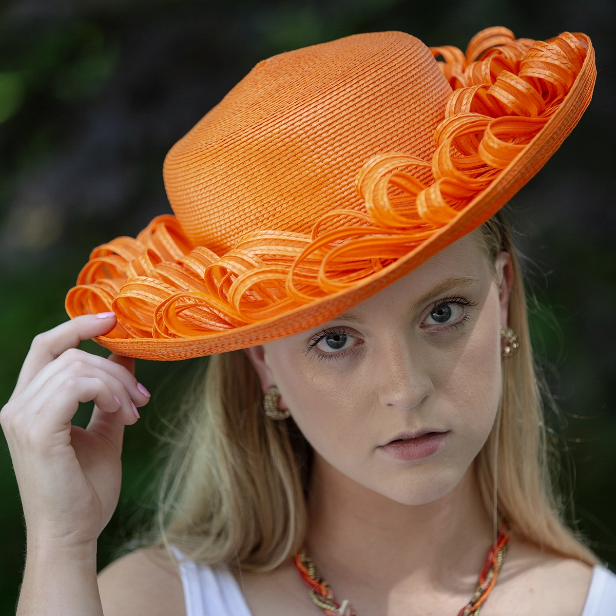 Orange wide brim straw hat on model