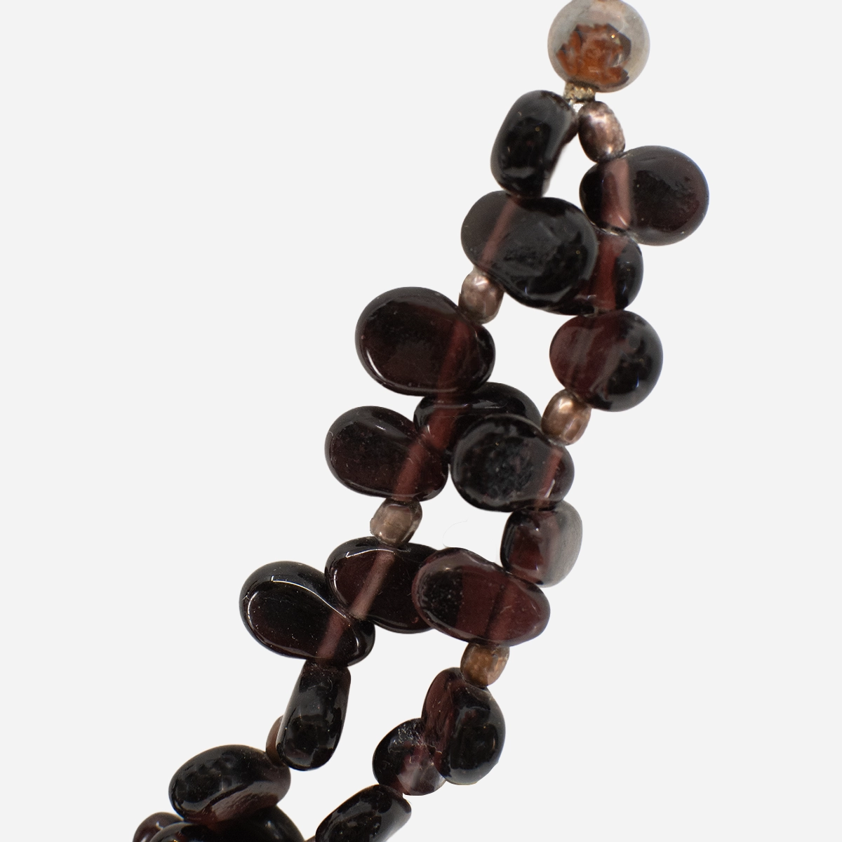Close-up of deep red polished garnet nugget beads with metallic spacer beads