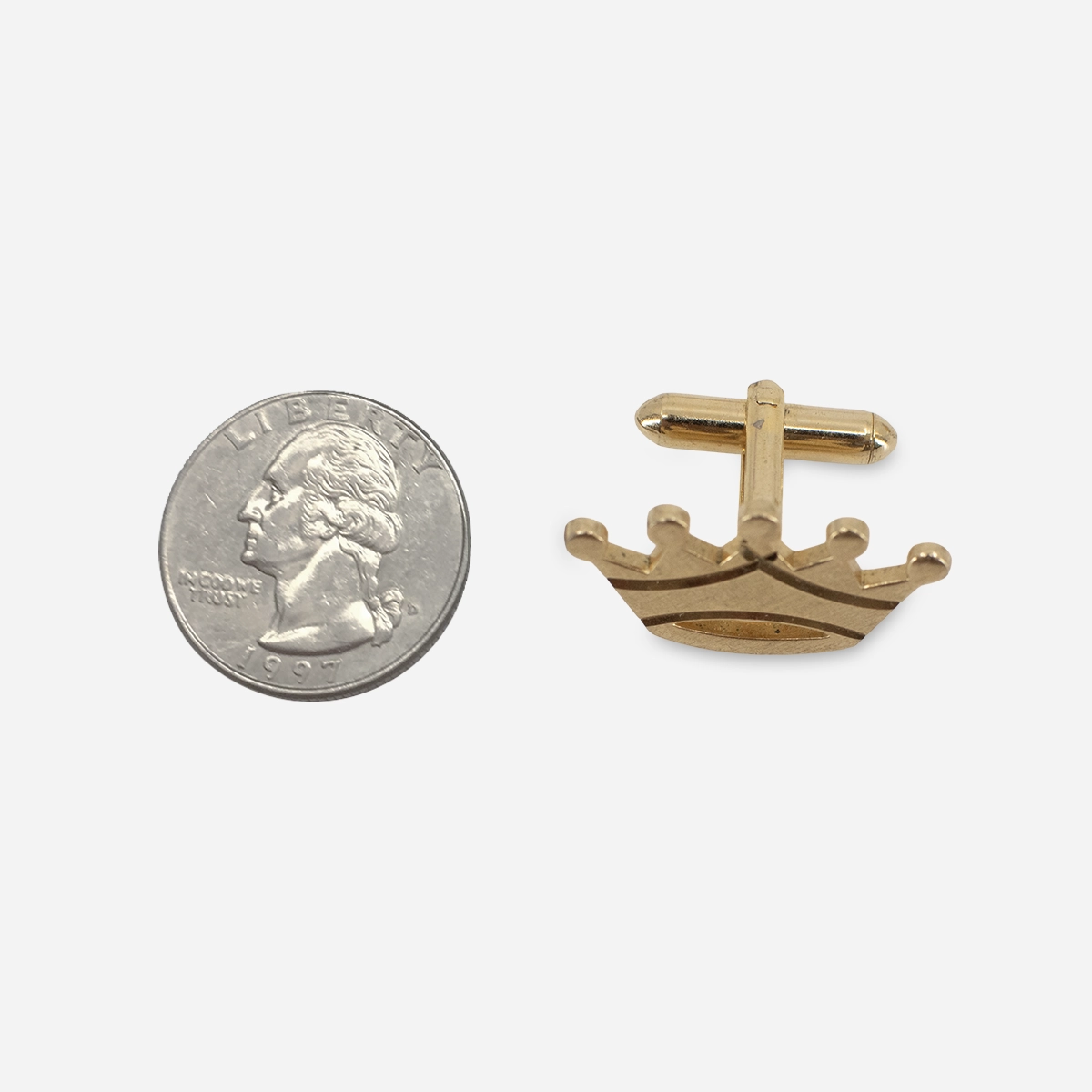 Swank Crown cufflinks 1970s Swank gold-tone crown cufflinks angled view with brushed diamond-cut finish.