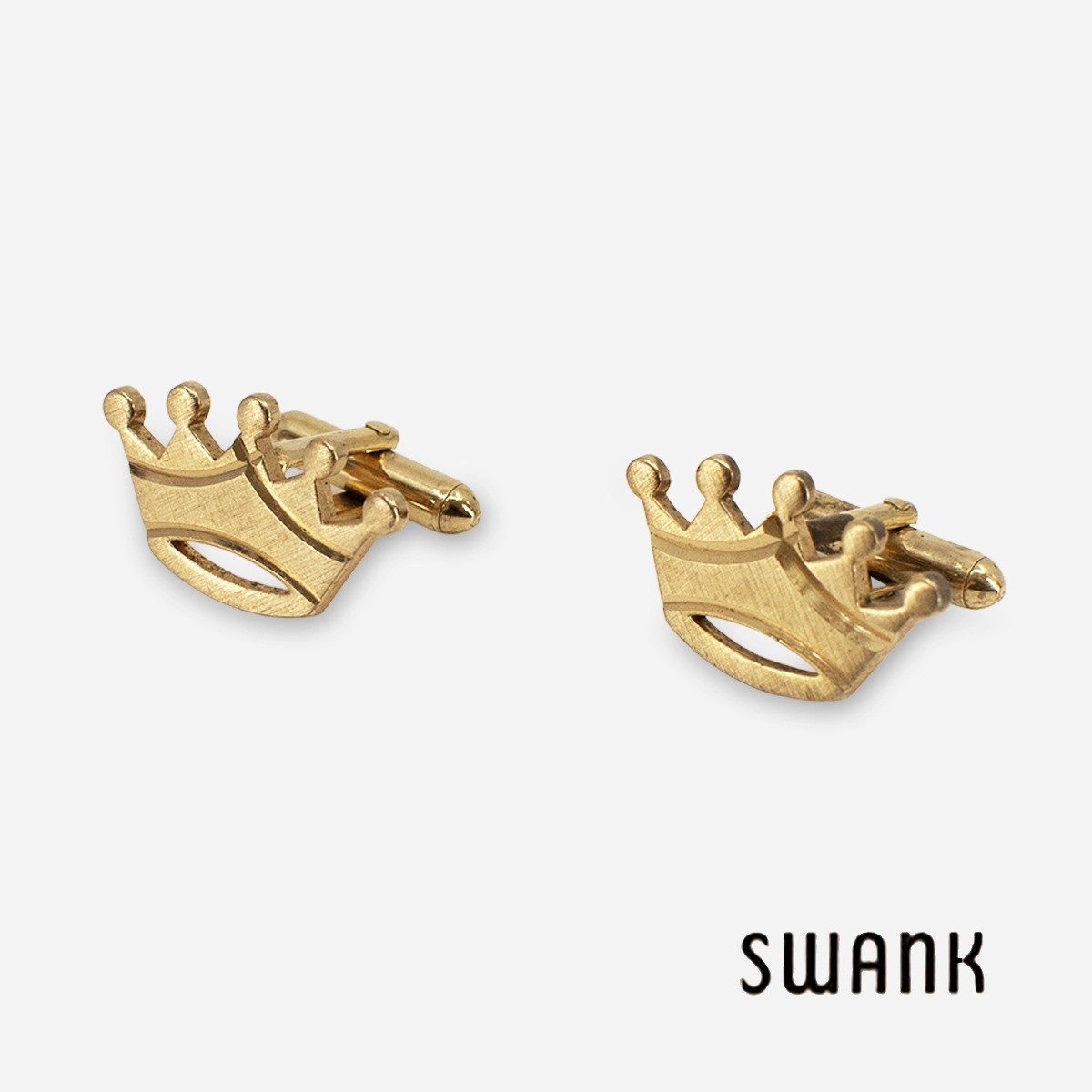 signed 1970s swank gold crown cufflinks signed 1970s Swank gold-tone crown cufflinks angled view with brushed diamond-cut finish.