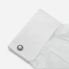 Art Deco cufflink shown on a white French cuff shirt.
