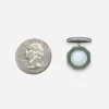 Vintage cufflink beside a quarter showing half-inch octagonal face.