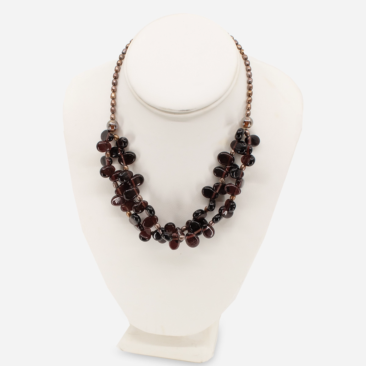Vintage garnet cluster necklace displayed on white bust, 17 inch length.