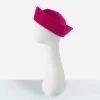 1970s pink straw hat Side view showing the rounded crown and sculptural upturned brim of the pink Breton hat.