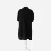 Black Chanel jacket Back view of Chanel black cotton knit jacket showing relaxed A-line silhouette, short sleeves, and perforated hem trim.