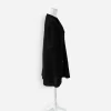 Chanel Black Perforated Side view of Chanel black short sleeve knit jacket showing textured cotton fabric, wide collar, and patch pocket.