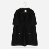 Chanel black cardigan Chanel black cotton knit jacket shown flat on pearl hanger with short sleeves, zip front, wide collar, self neck tie, and patch pockets.