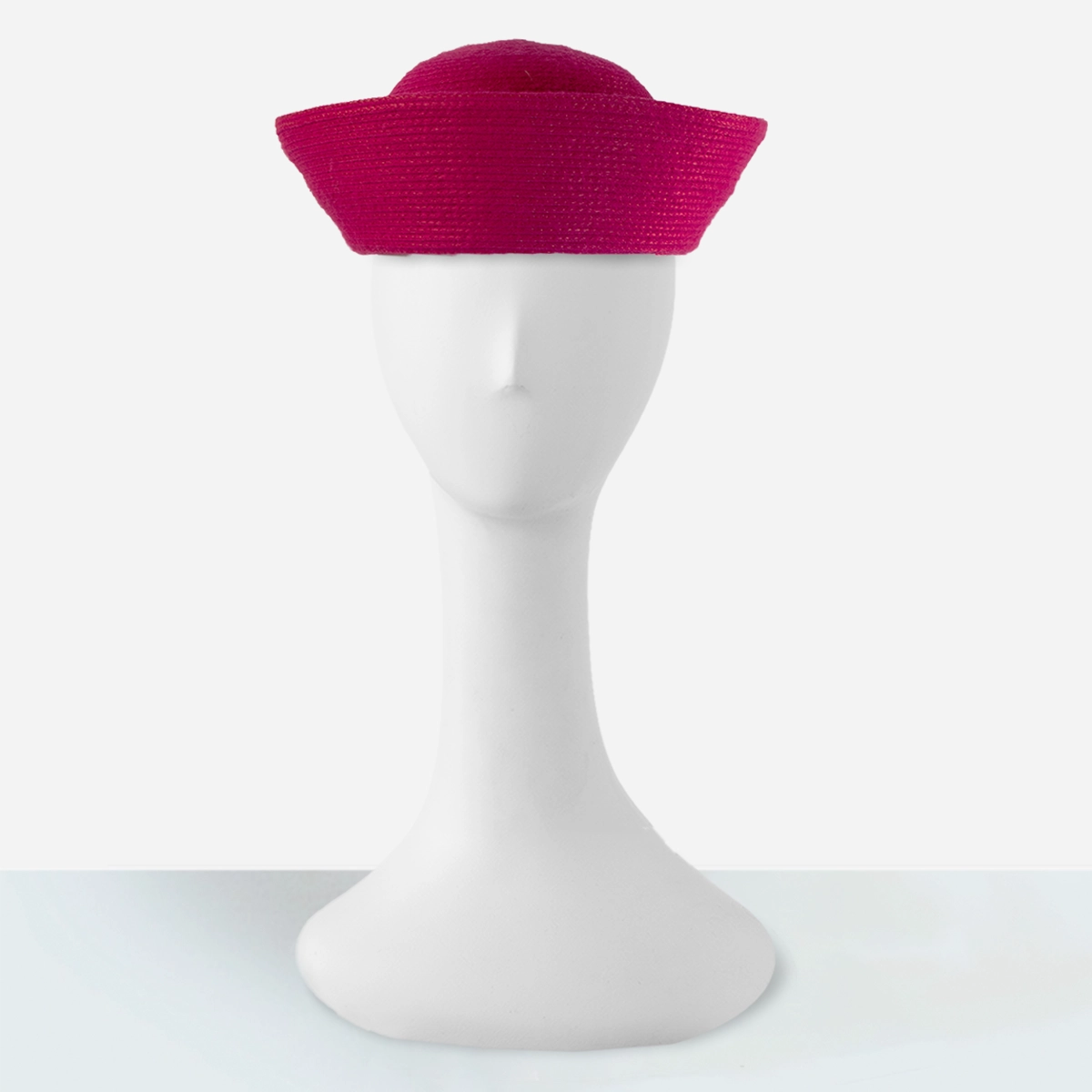Straight-on view of the fuchsia pink Breton hat showing the high rolled brim and rounded crown.