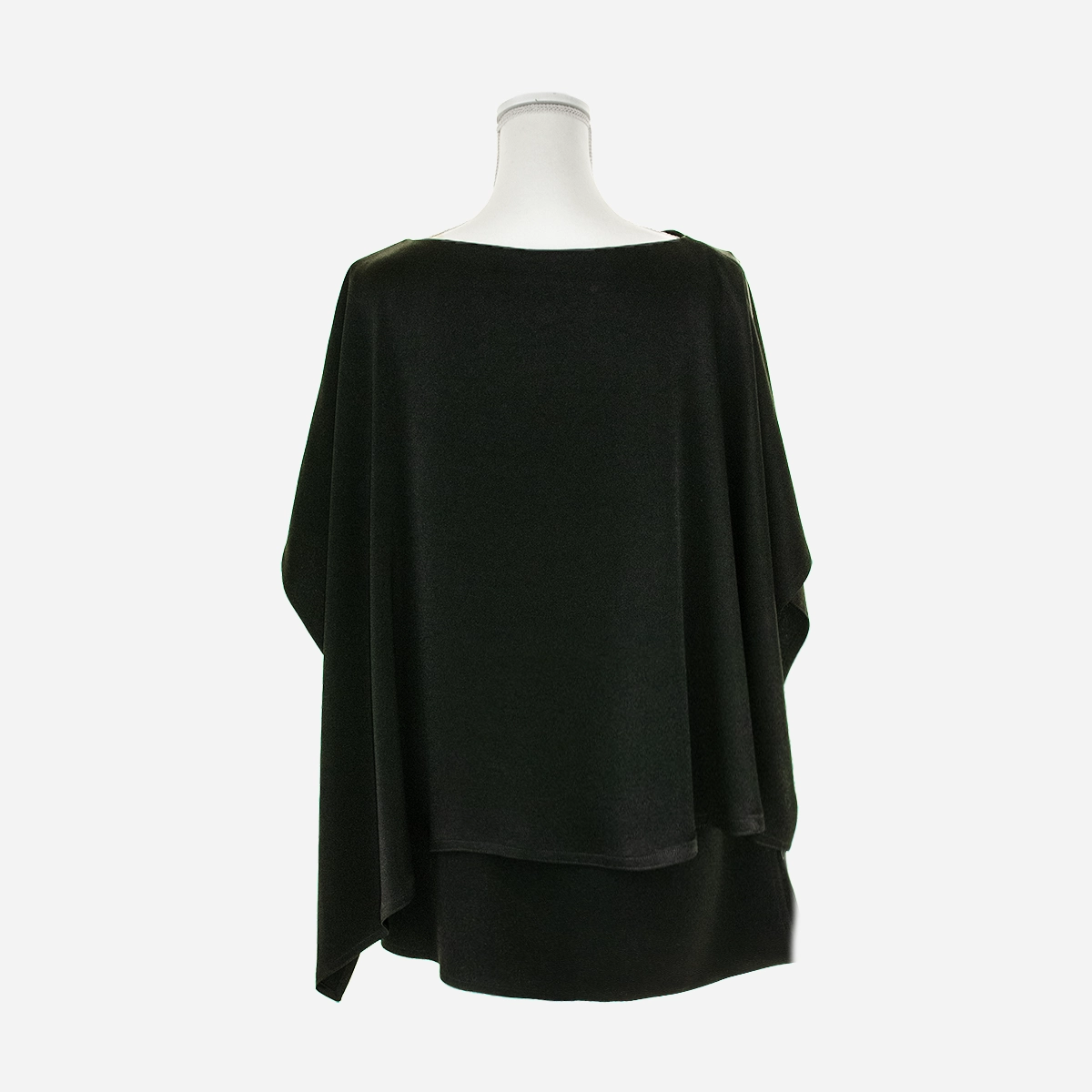 Front view of black wool-blend poncho top with layered draped hem