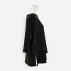 Side view showing layered tank and flowing black poncho overlay