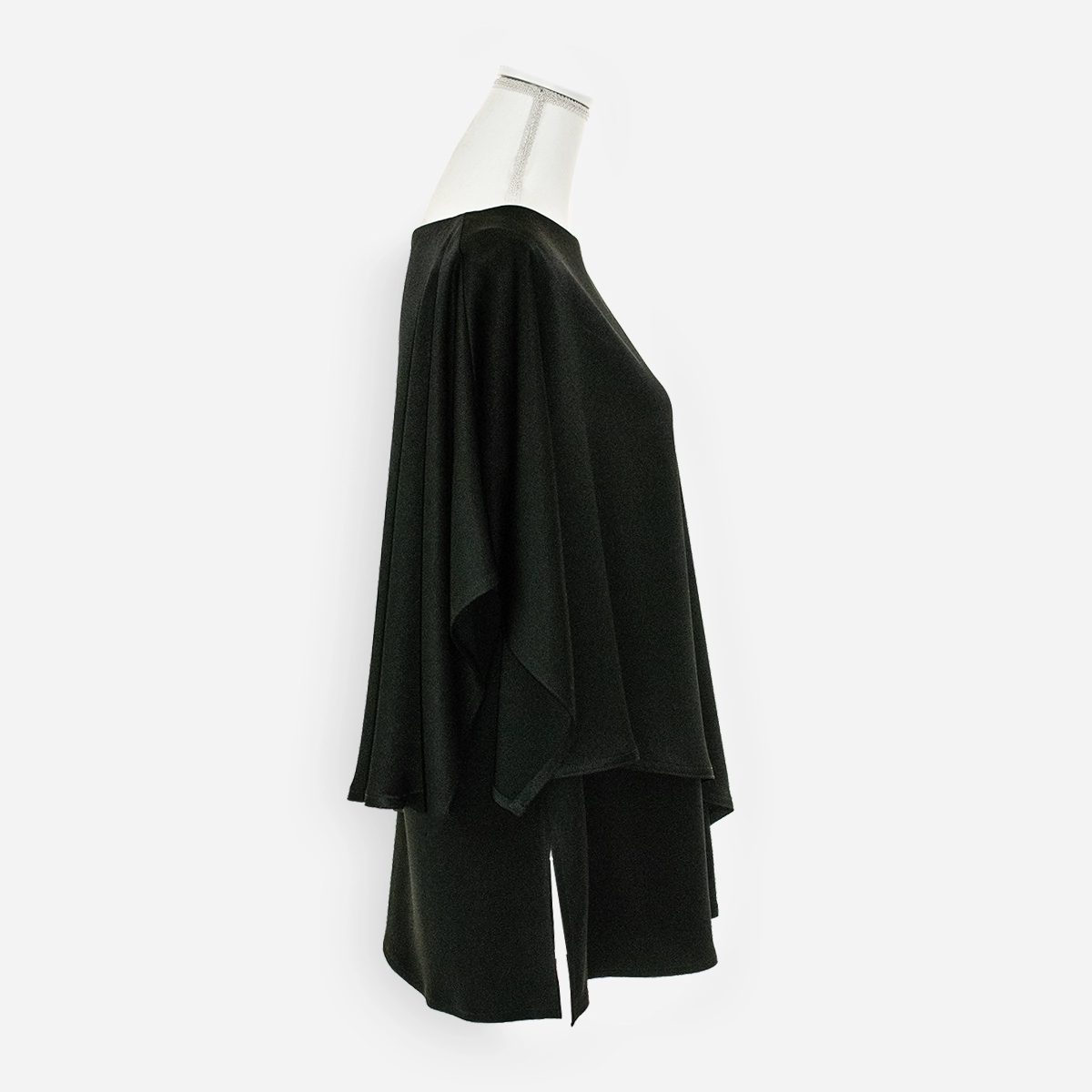 Side view showing layered tank and flowing black poncho overlay