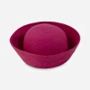 vintage 1970s pink hat Overhead view of a fuchsia pink synthetic straw Breton hat with a rounded crown and deeply upturned brim.