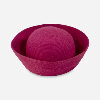 Overhead view of a fuchsia pink synthetic straw Breton hat with a rounded crown and deeply upturned brim.