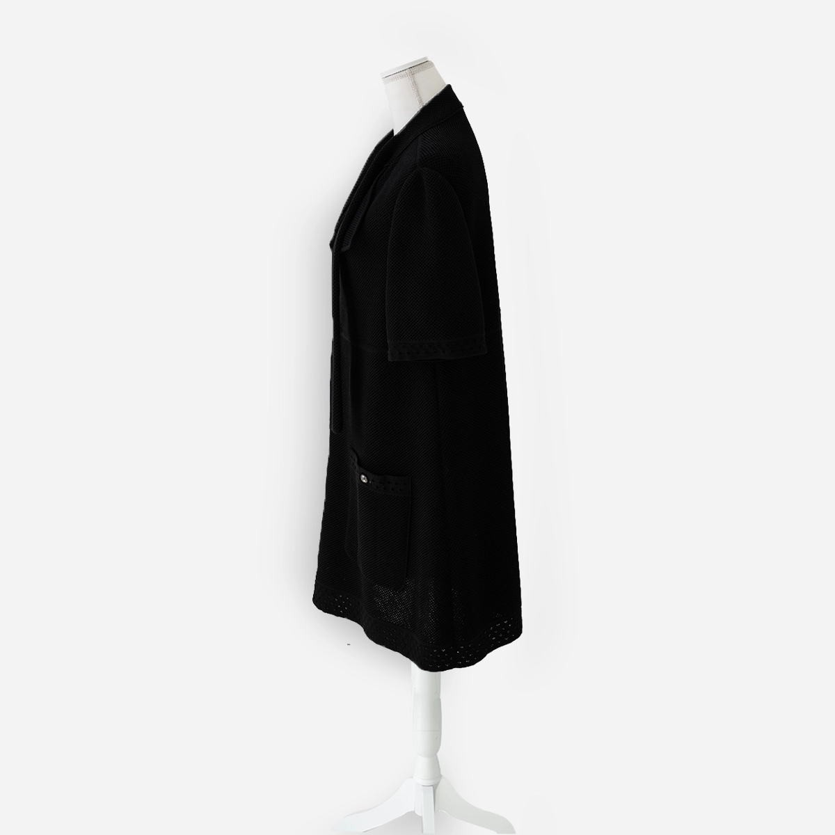 vintage chanel jacket with tie Angled side view of Chanel black cotton knit jacket with full front zipper, self neck tie, and perforated trim at hem.