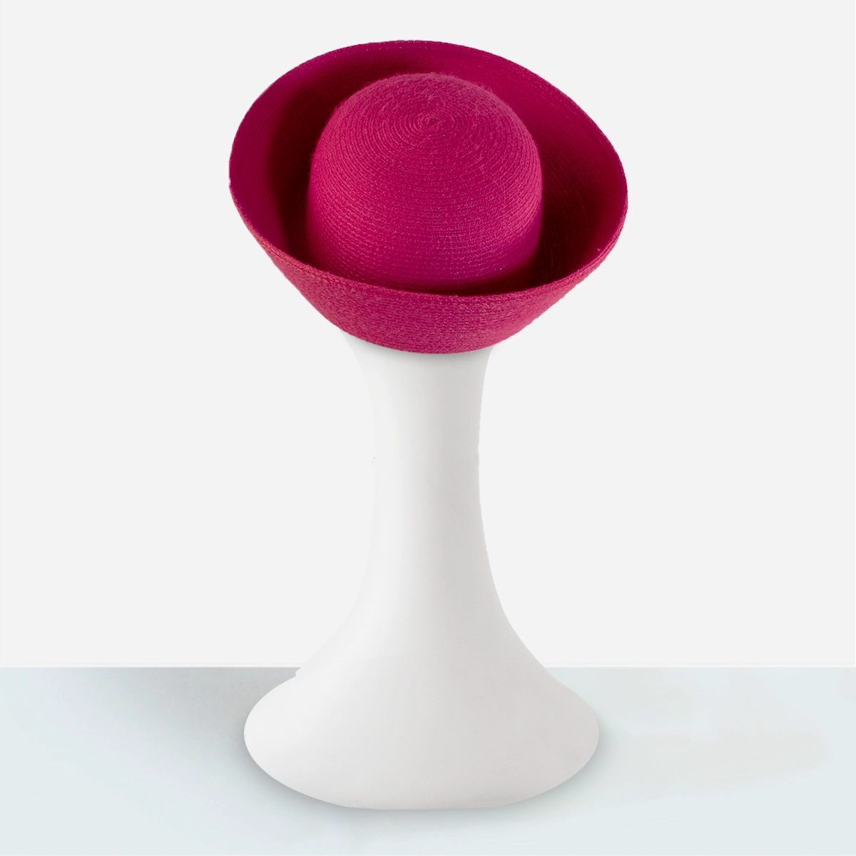 Rear view of the fuchsia Breton hat on a mannequin showing the rounded crown within the high brim