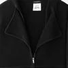 womens double collar jacket Close-up of Chanel black cotton knit jacket neckline showing textured fabric, wide lapel collar, zipper pull, and interior label.