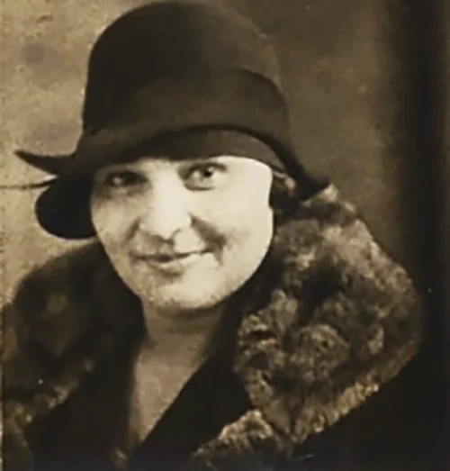 Madge wearing a cloche hat and fur collar, late 1920s portrait.